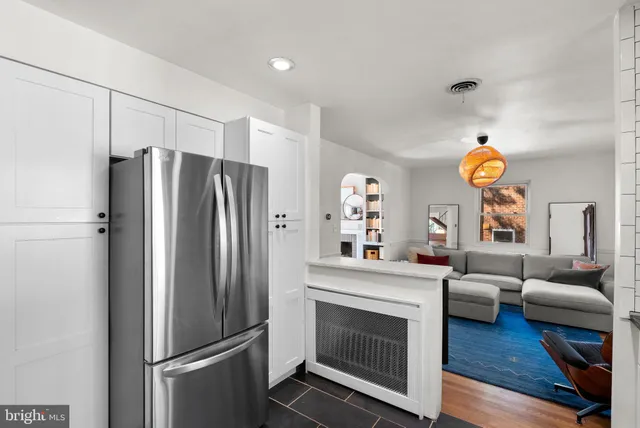 a kitchen with a refrigerator and a couch