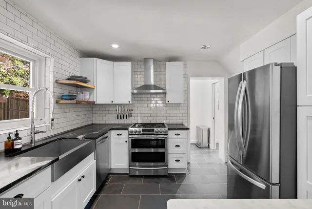 a kitchen with a refrigerator and a sink