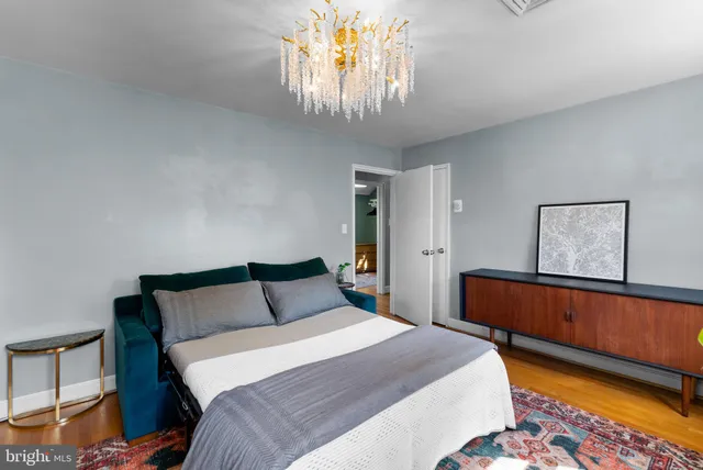 a bedroom with a bed and a chandelier