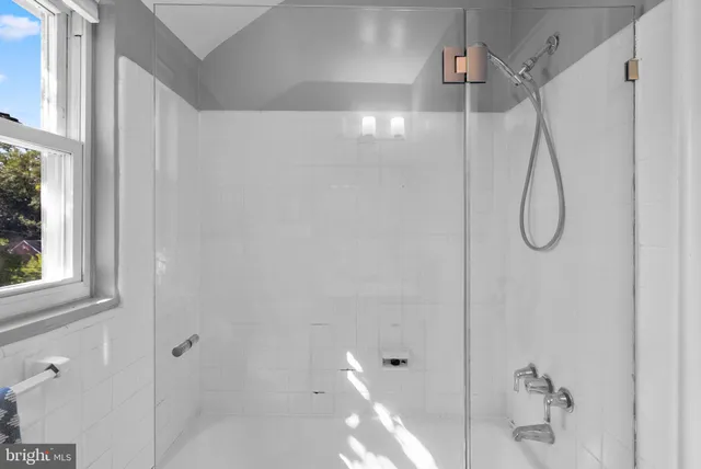 a bathroom with a glass shower door