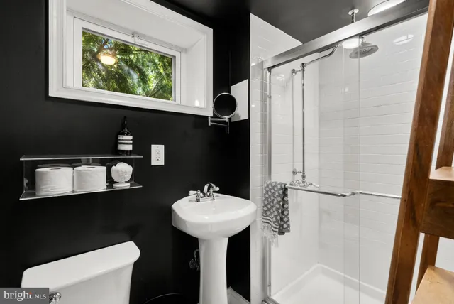 a bathroom with a sink toilet and a mirror