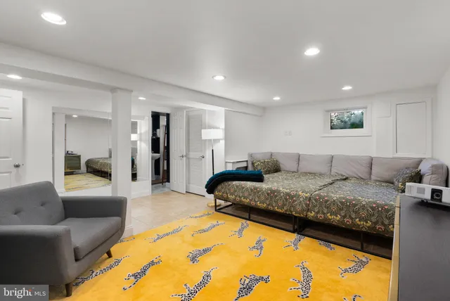 a living room with furniture and a bed