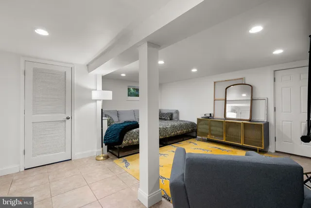 a bedroom with furniture and a mirror