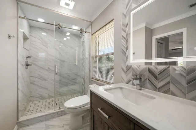 a bathroom with a sink toilet and shower