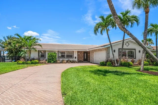 a front view of a house with a garden and yard