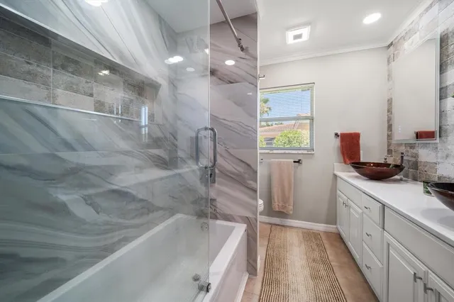 a bedroom with a bed and a potted plant