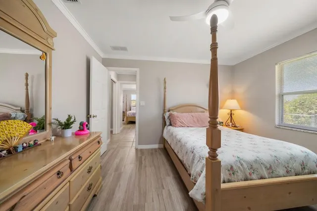 a bedroom with a bed and a dresser in it
