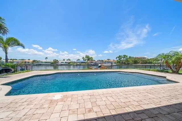 a view of swimming pool with outdoor seating and plants