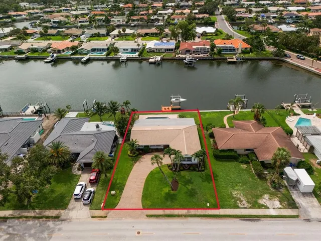 an aerial view of a house with a lake view