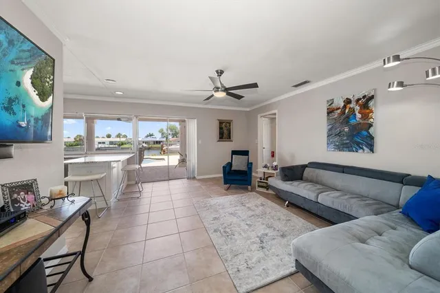 a living room with furniture and a dining table with kitchen view