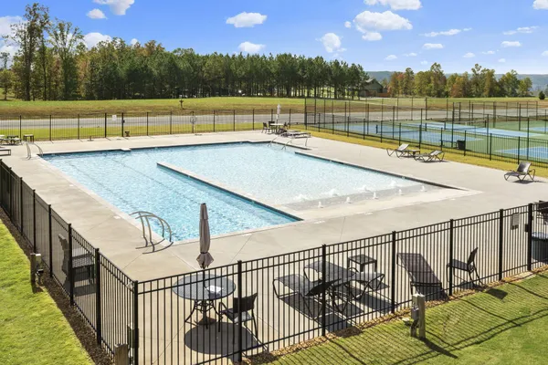 a view of a house with a swimming pool and sitting area
