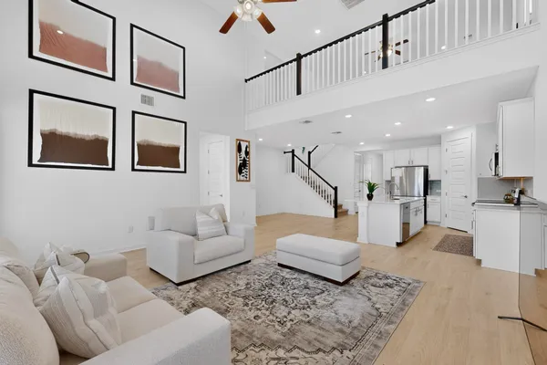 a living room with furniture and kitchen view