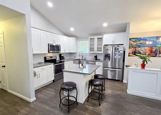 a kitchen with white cabinets and white stainless steel appliances