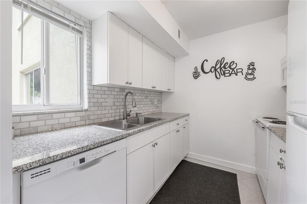 3206 West Azeele Street, Unit 129 Tampa, FL 33609 - Photo 11 of 30 a kitchen with a sink and cabinets