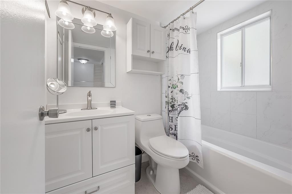 3206 West Azeele Street, Unit 129 Tampa, FL 33609 - Photo 18 of 30 a bathroom with a sink a toilet and shower