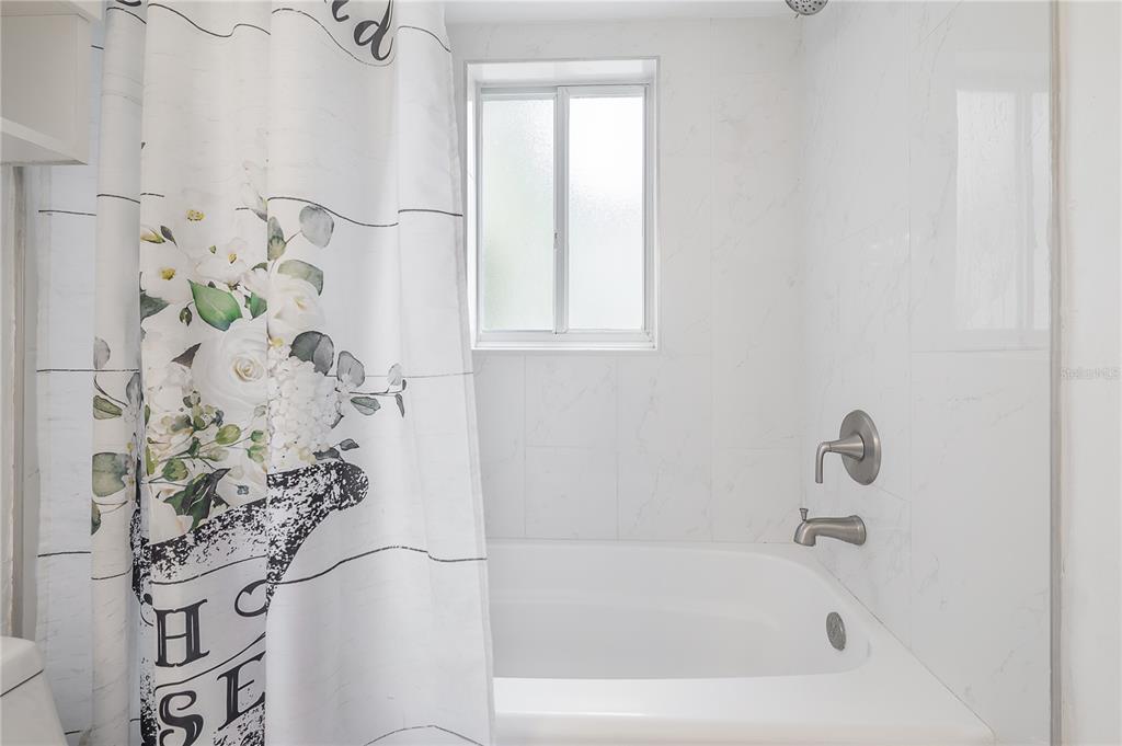 3206 West Azeele Street, Unit 129 Tampa, FL 33609 - Photo 19 of 30 a bathroom with a bathtub and shower