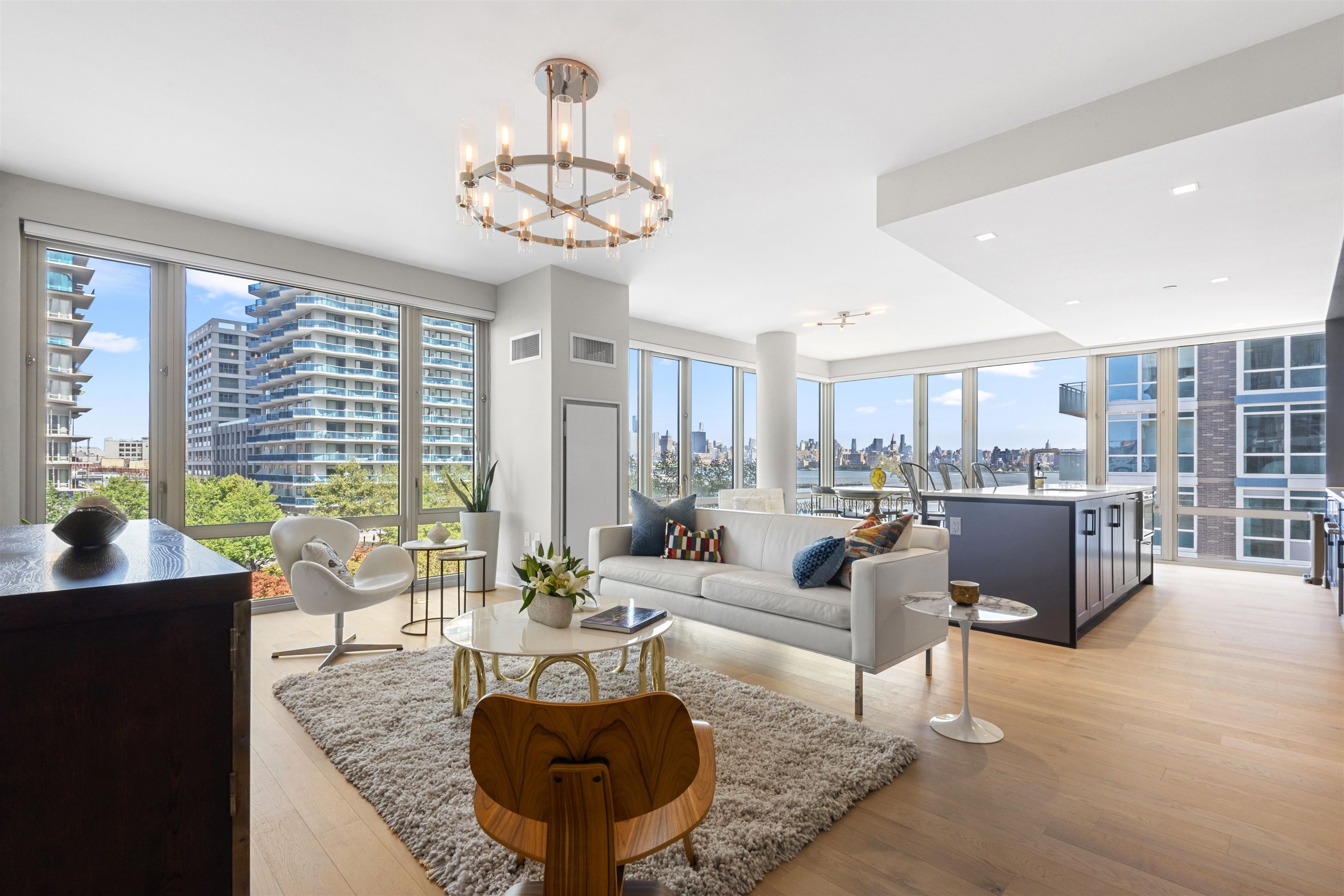 2 Shore Lane, Unit 404 Jersey City, NJ 07310 - Photo 1 of 34 a living room with furniture and a large window