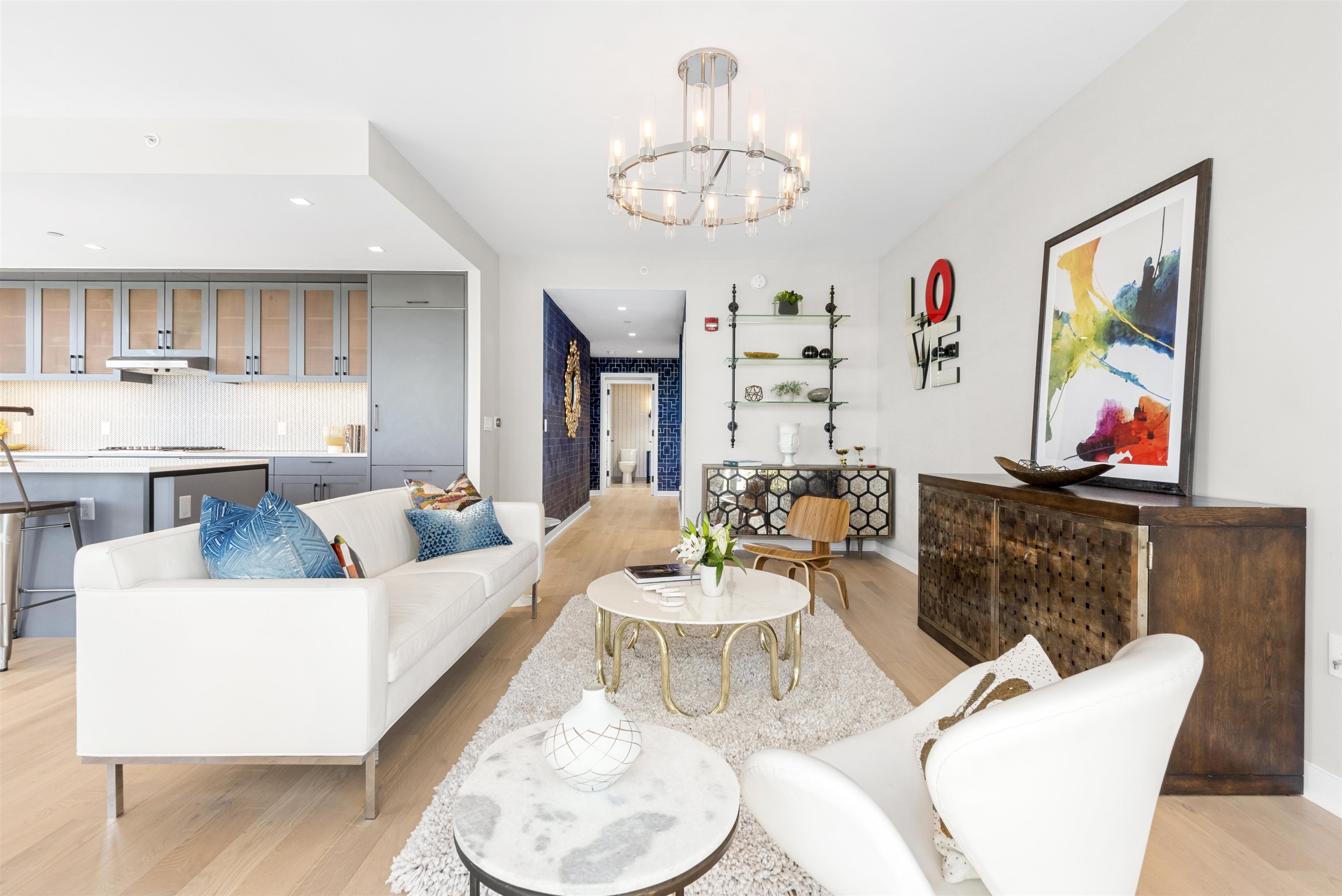 2 Shore Lane, Unit 404 Jersey City, NJ 07310 - Photo 11 of 34 a living room with furniture and a chandelier