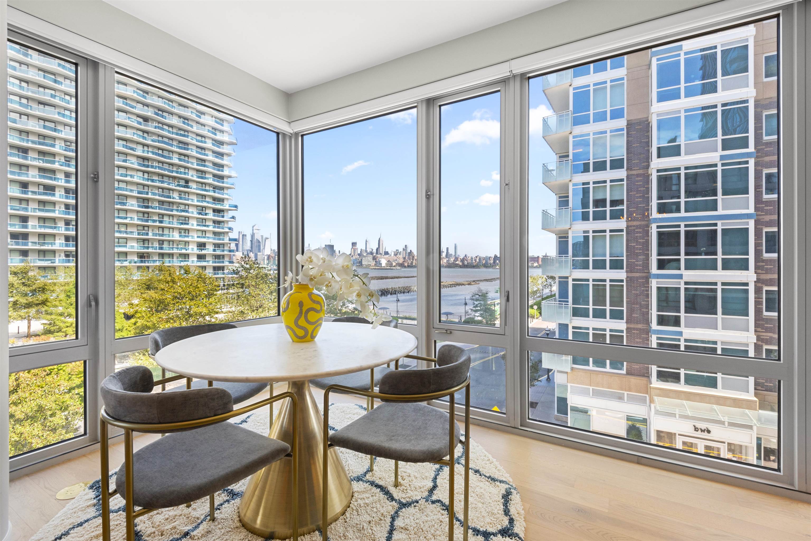 2 Shore Lane, Unit 404 Jersey City, NJ 07310 - Photo 12 of 34 a view of a dining room with furniture and a large window
