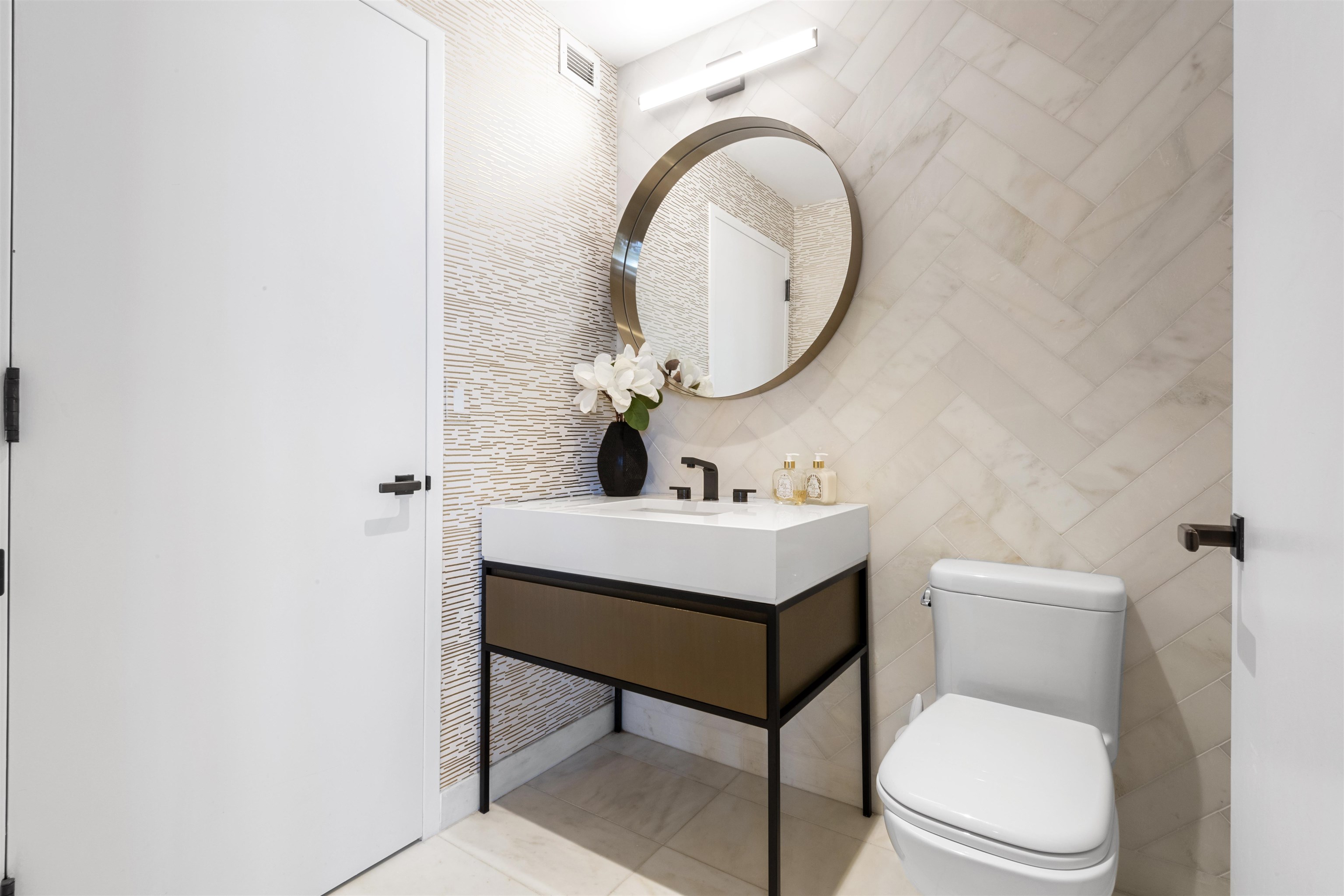 2 Shore Lane, Unit 404 Jersey City, NJ 07310 - Photo 15 of 34 a bathroom with a toilet a sink and a mirror