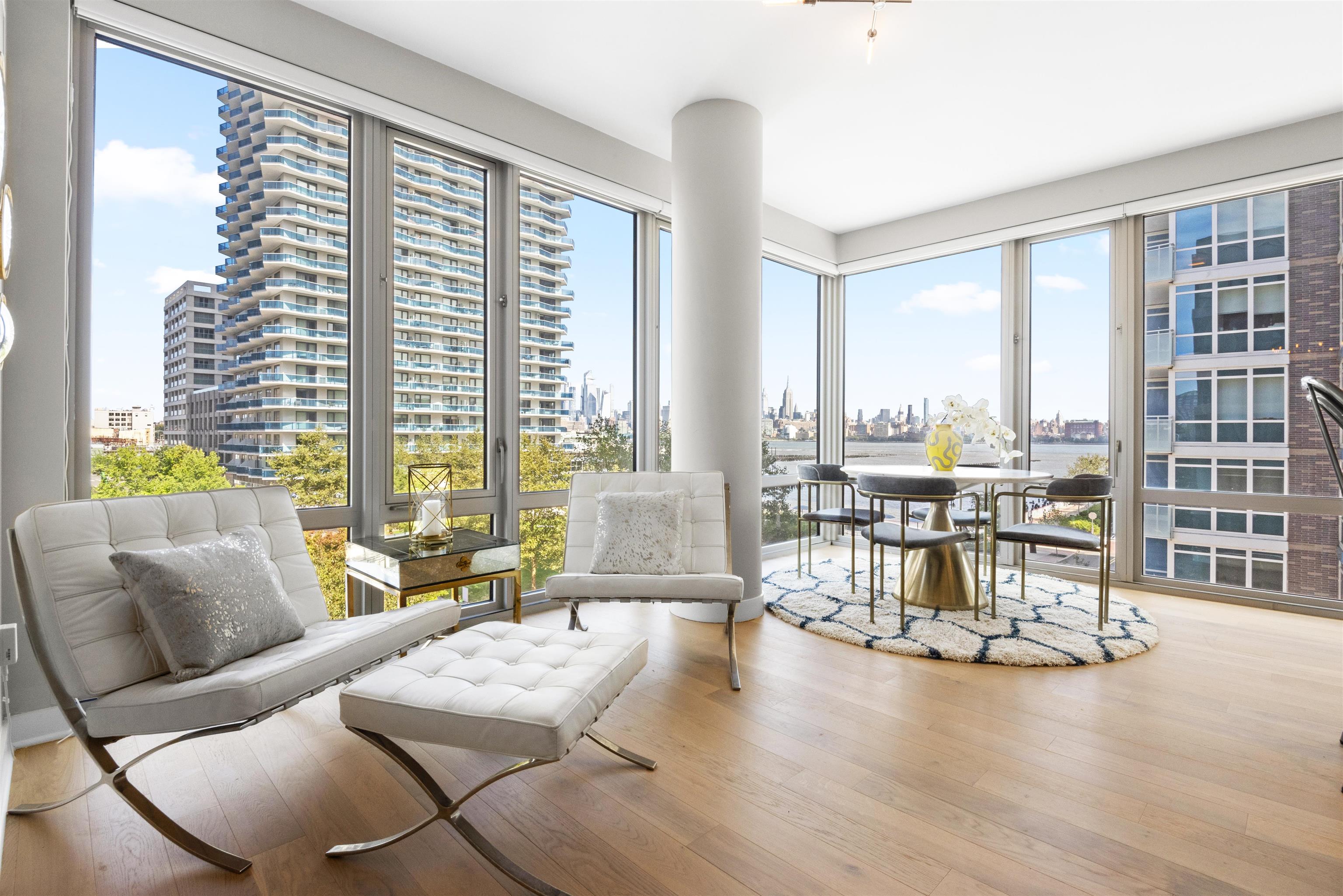 2 Shore Lane, Unit 404 Jersey City, NJ 07310 - Photo 2 of 34 a living room with furniture and a table