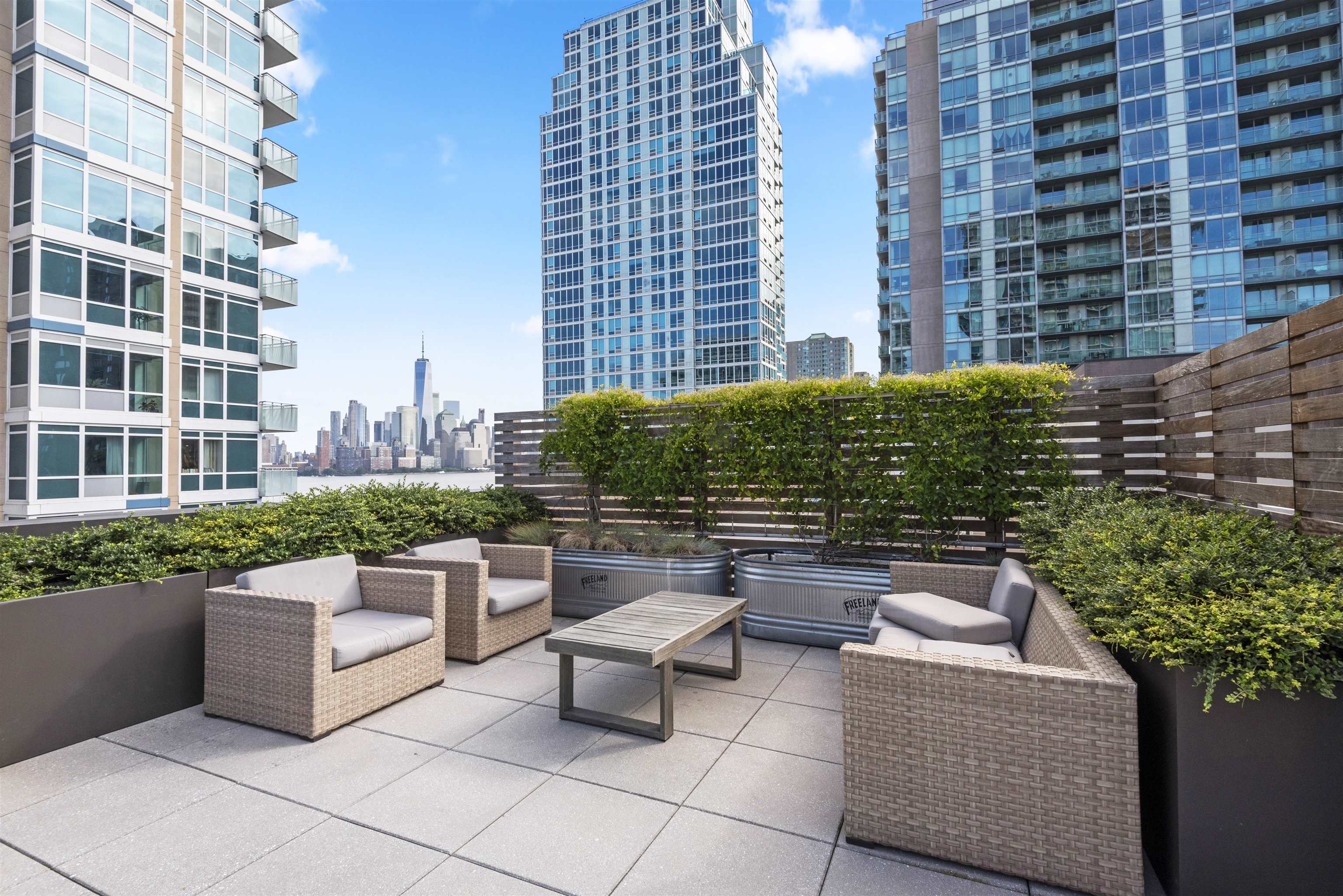 2 Shore Lane, Unit 404 Jersey City, NJ 07310 - Photo 24 of 34 a view of a patio with couches and potted plants