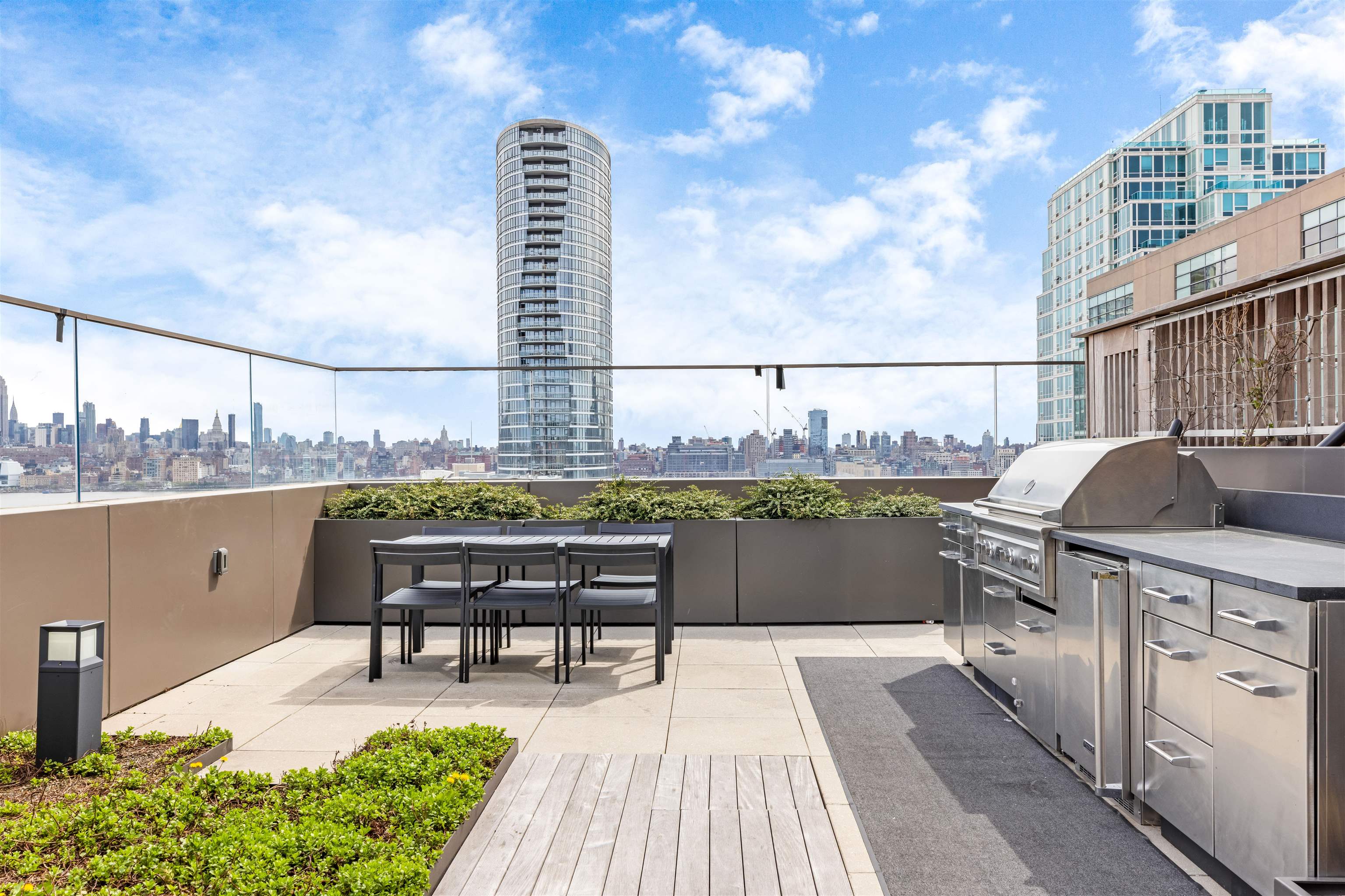 2 Shore Lane, Unit 404 Jersey City, NJ 07310 - Photo 31 of 34 a terrace with a table and chairs