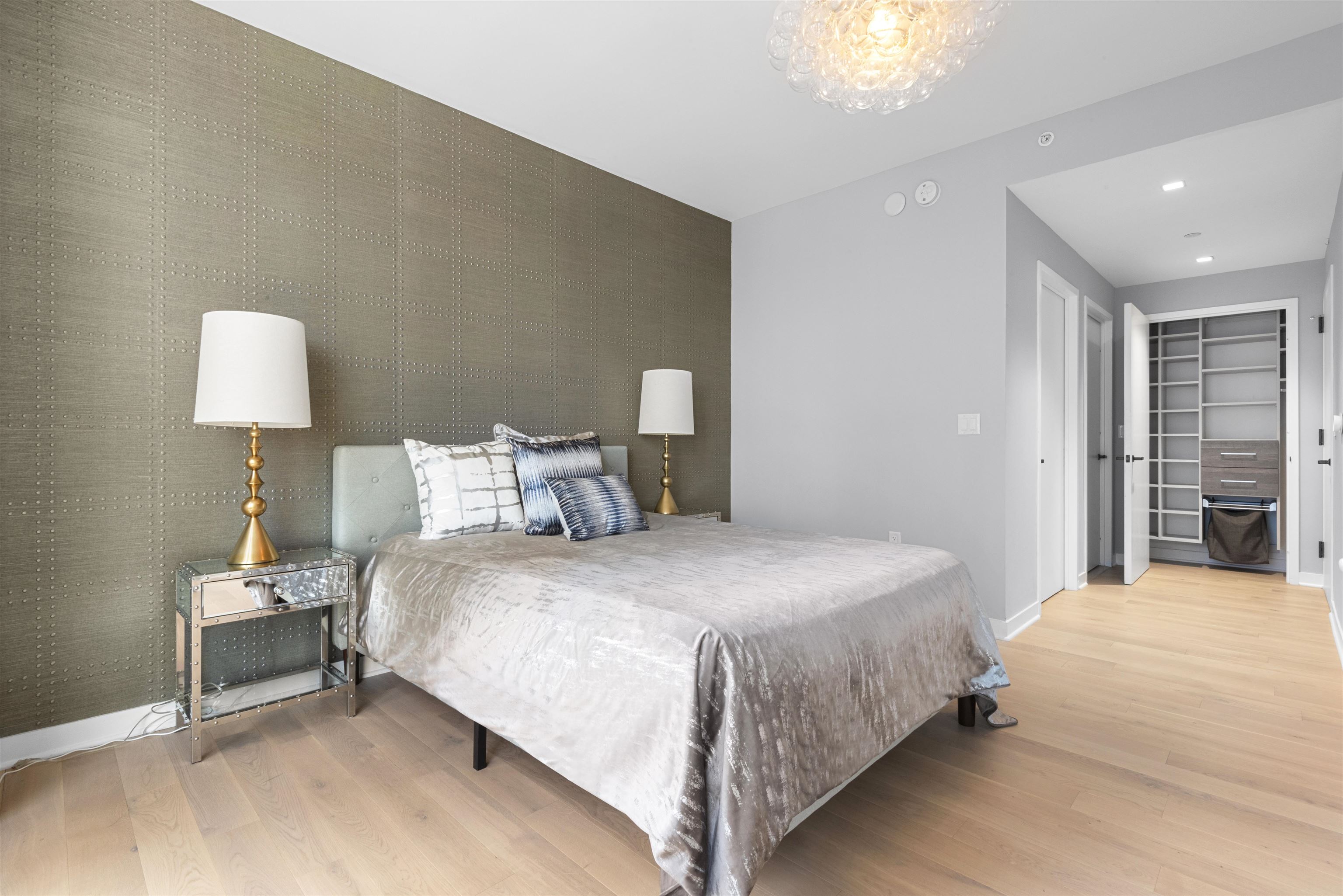 2 Shore Lane, Unit 404 Jersey City, NJ 07310 - Photo 5 of 34 a bedroom with a bed and a lamp