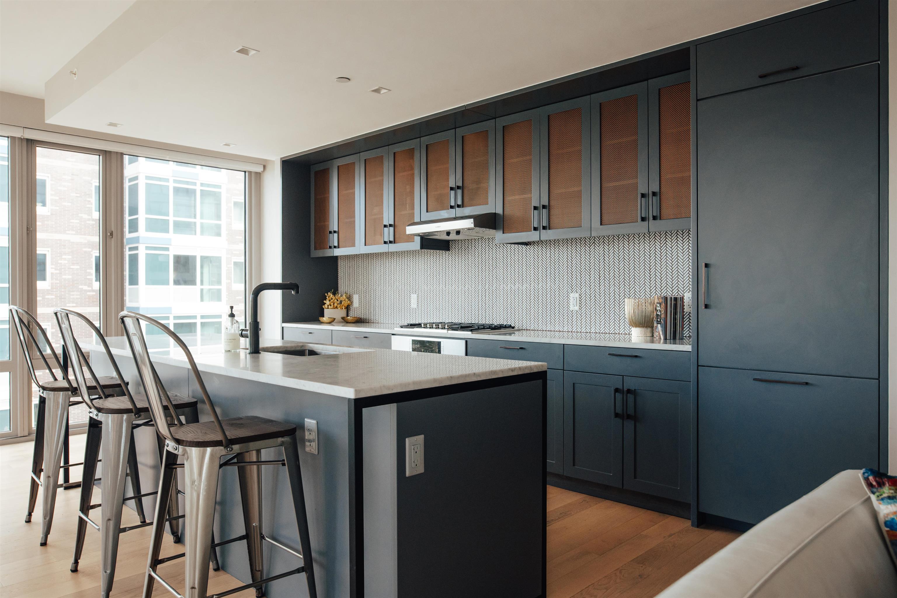 2 Shore Lane, Unit 404 Jersey City, NJ 07310 - Photo 8 of 34 a kitchen with stainless steel appliances granite countertop a sink a stove a dining table and chairs