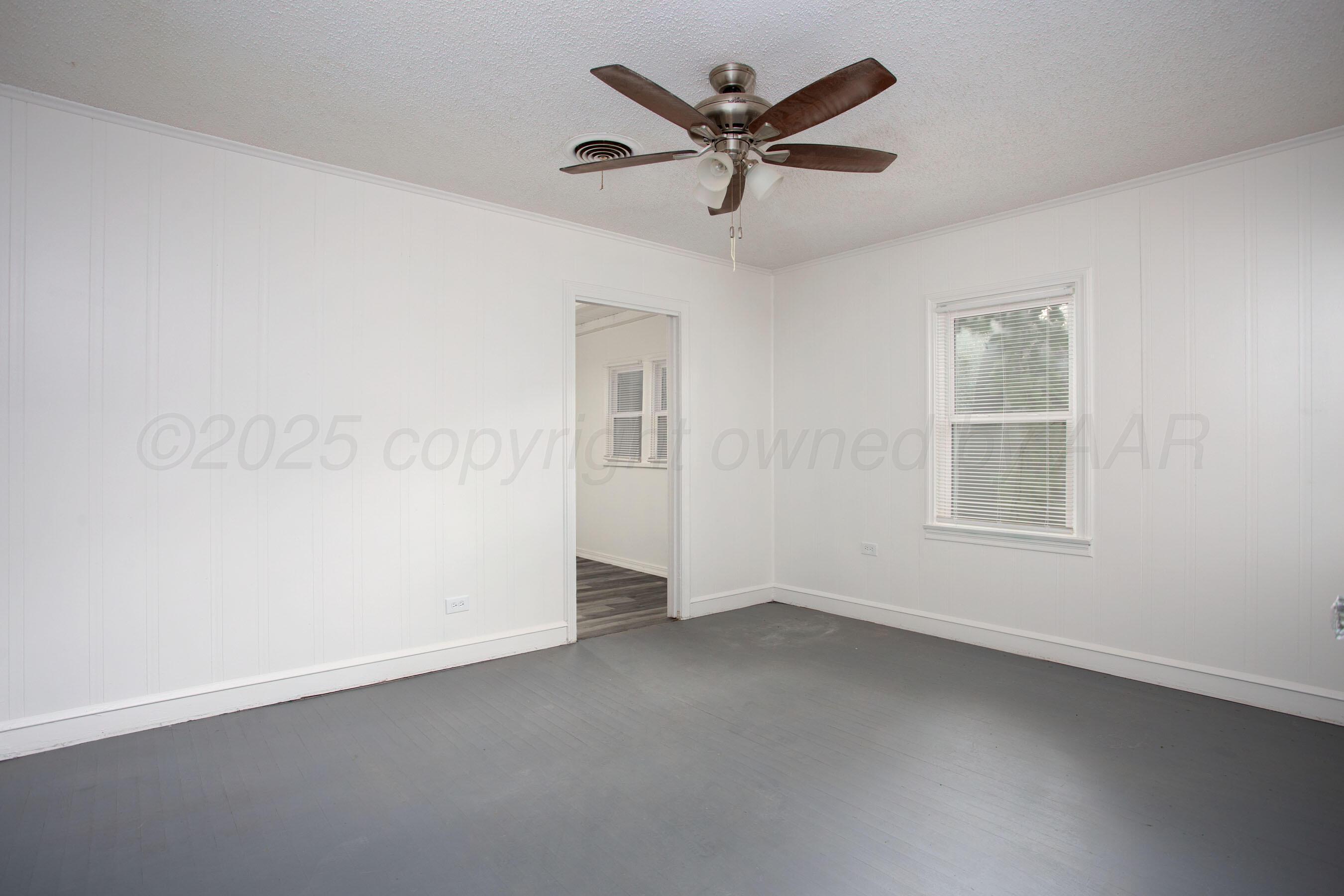 826 Sunset Terrace Amarillo, TX 79106 - Photo 19 of 28 an empty room with a window and a fan