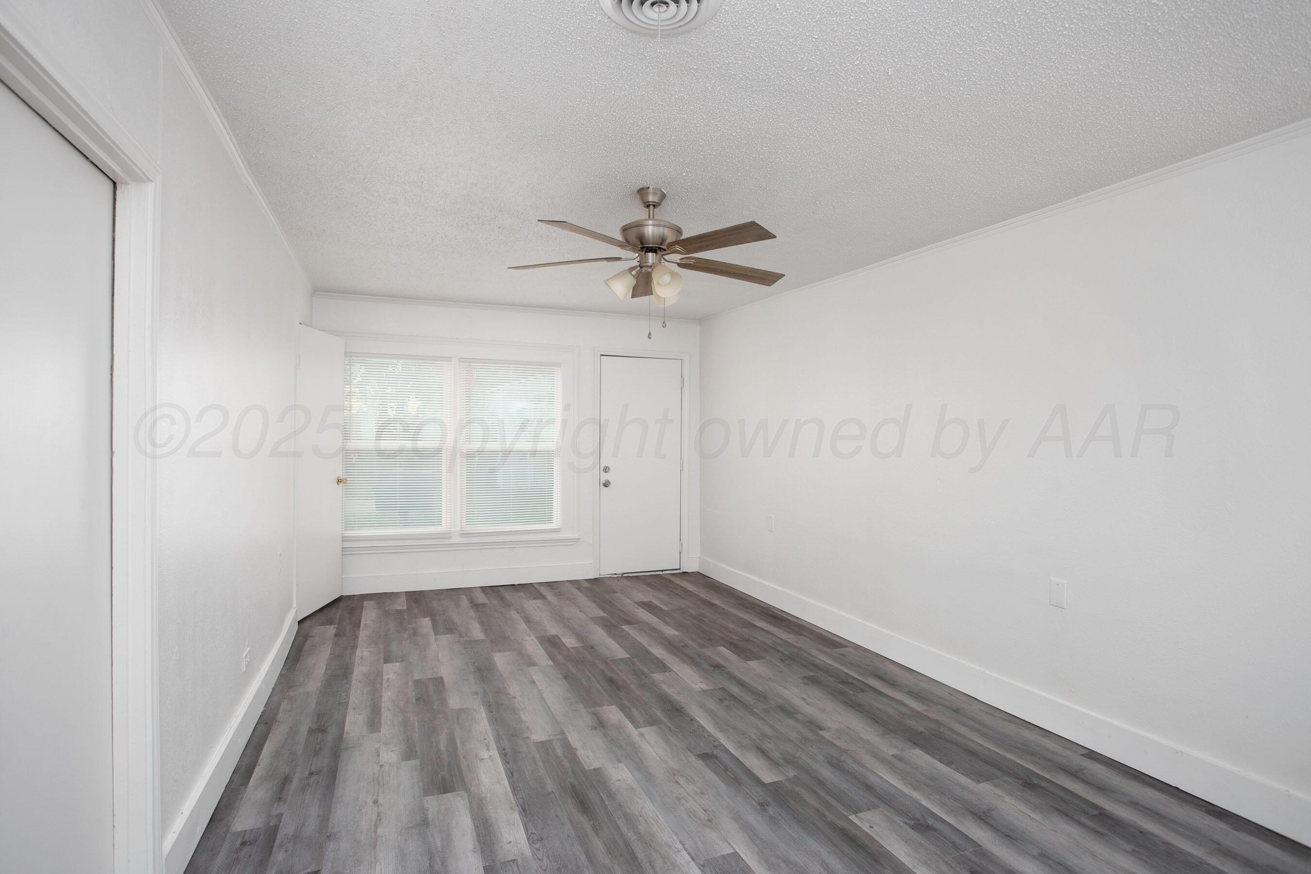 826 Sunset Terrace Amarillo, TX 79106 - Photo 25 of 28 wooden floor in an empty room with a window