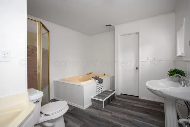 a bathroom with a sink toilet a mirror and shower