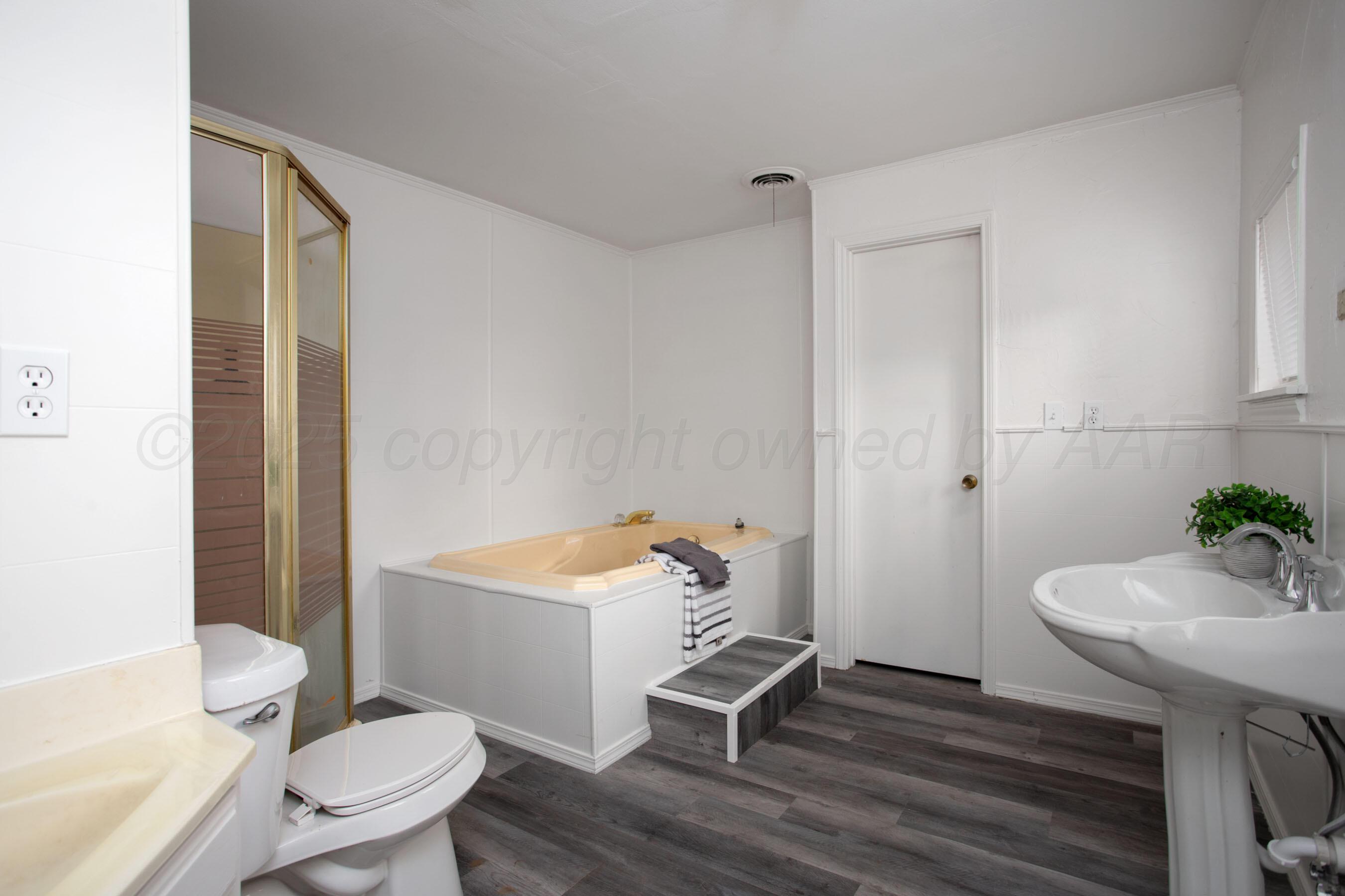 826 Sunset Terrace Amarillo, TX 79106 - Photo 27 of 28 a bathroom with a sink toilet a mirror and shower
