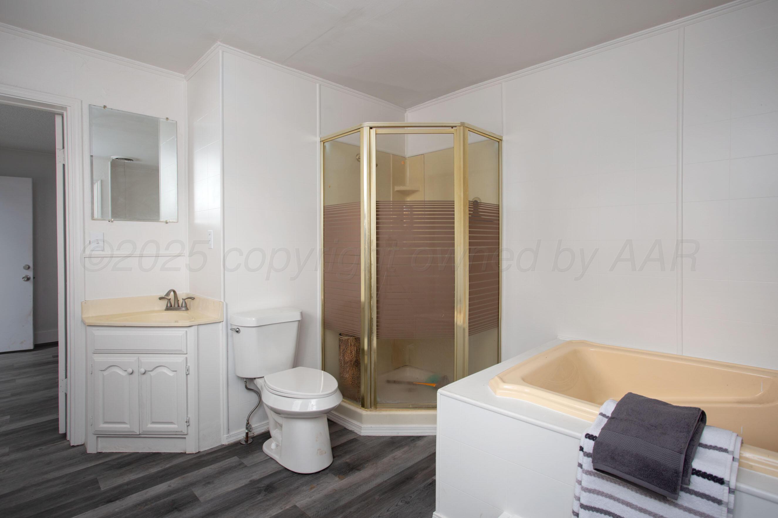 826 Sunset Terrace Amarillo, TX 79106 - Photo 28 of 28 a bathroom with a toilet a sink and a bathtub
