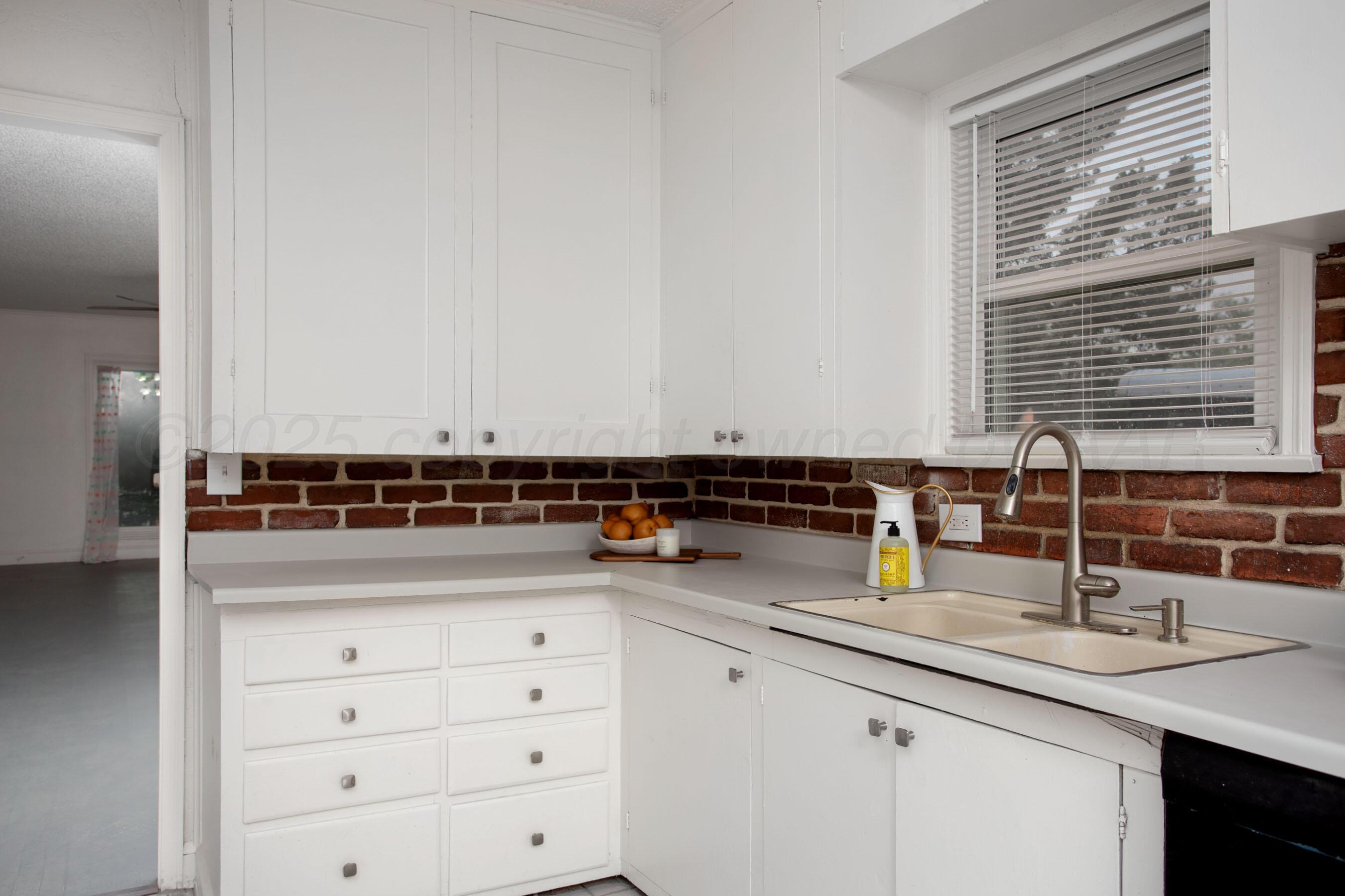 826 Sunset Terrace Amarillo, TX 79106 - Photo 6 of 28 a kitchen with cabinets appliances a sink and a window