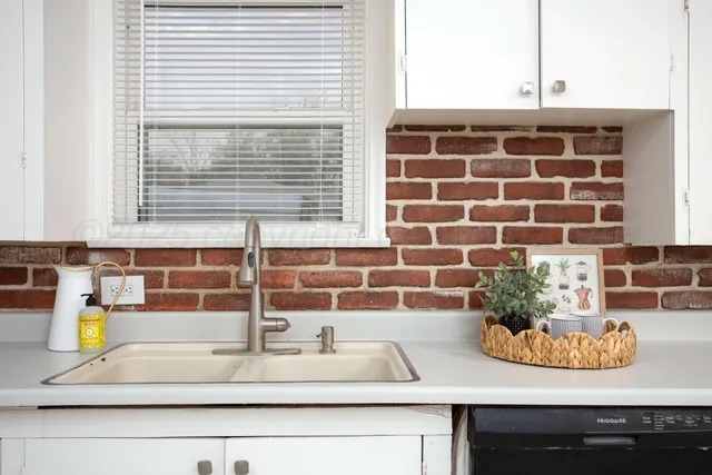 a bathroom with a sink and a window