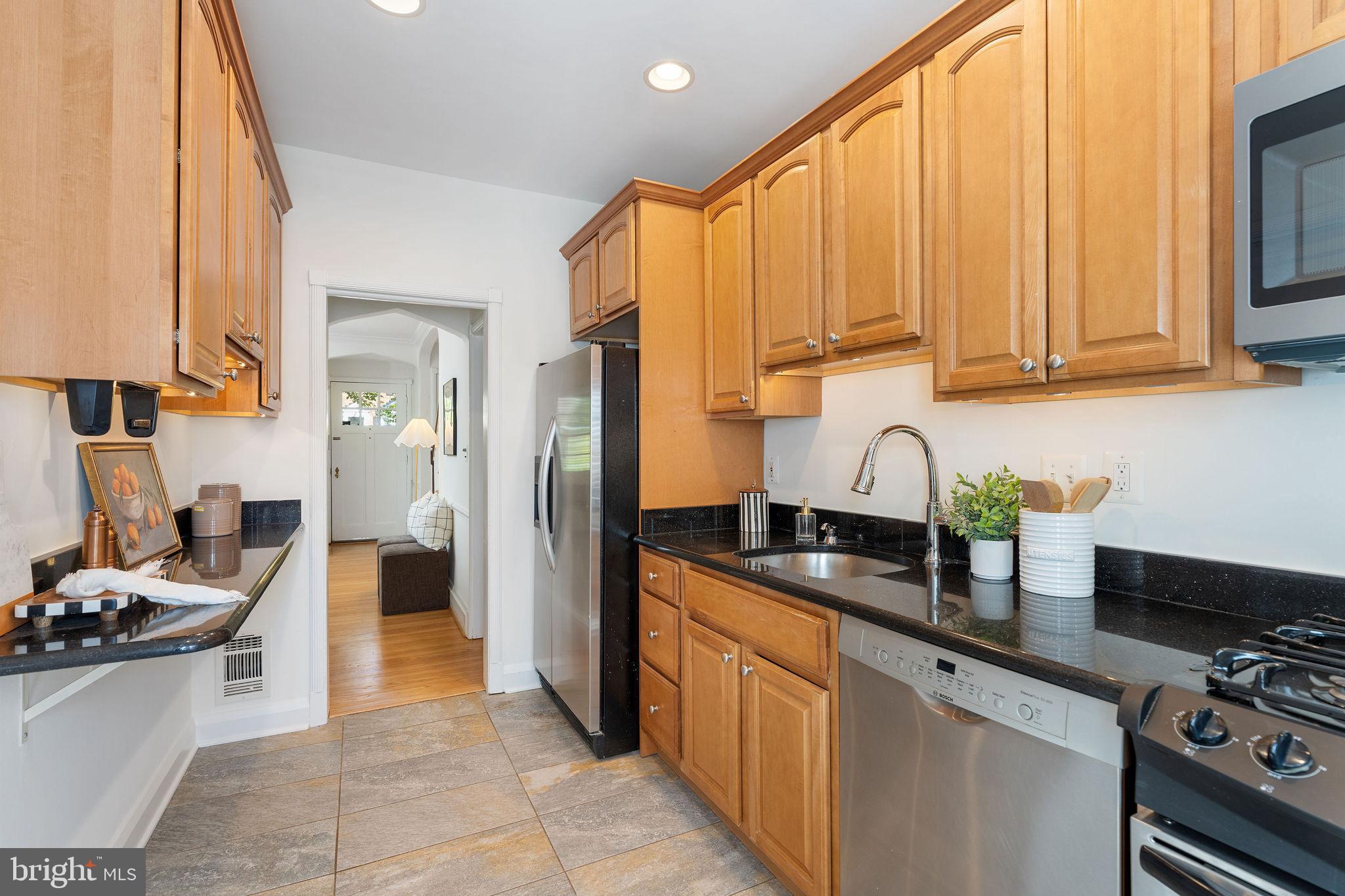 19 Dunkirk Road Baltimore, MD 21212 - Photo 11 of 37 a kitchen with stainless steel appliances a stove a sink a refrigerator and cabinets
