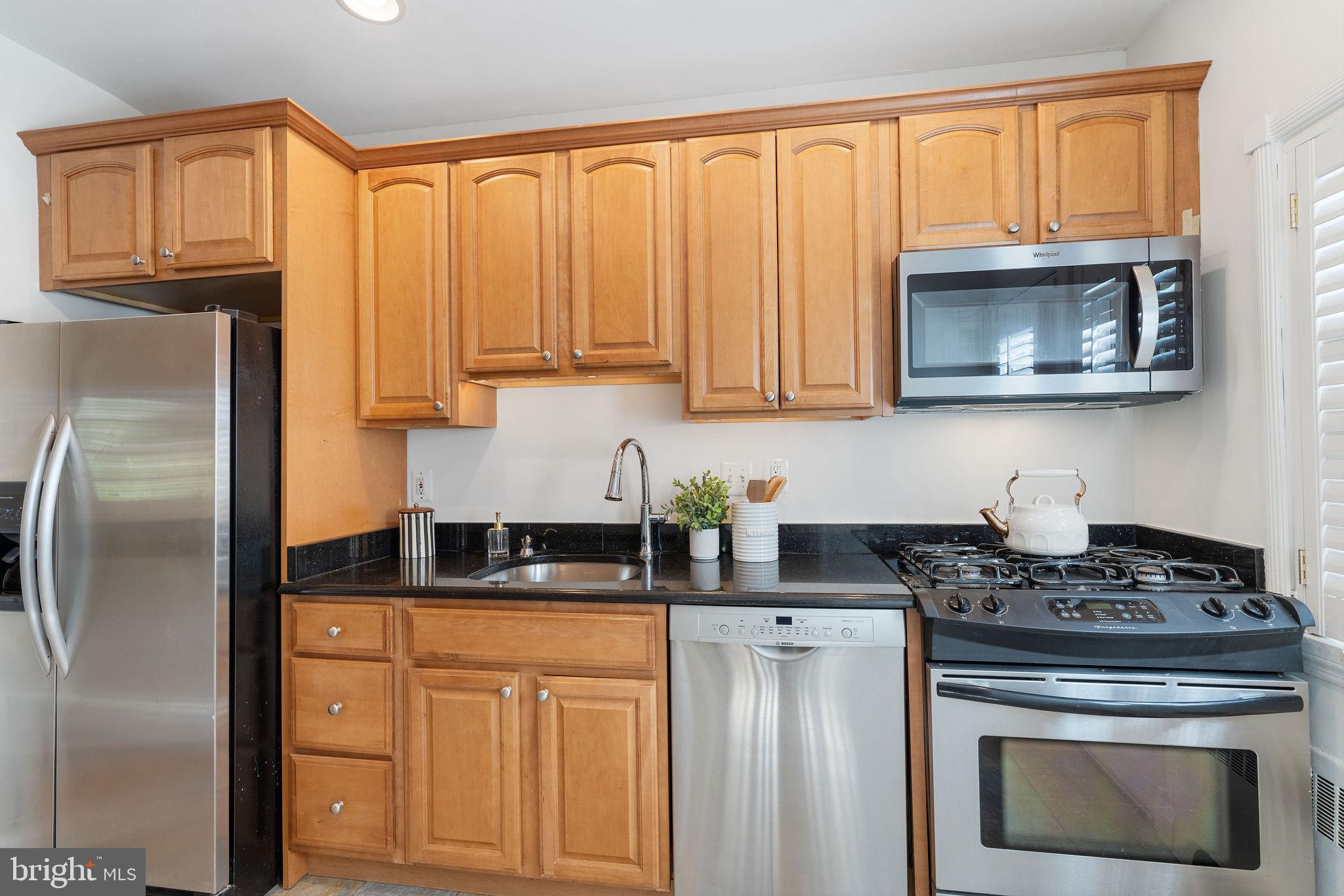 19 Dunkirk Road Baltimore, MD 21212 - Photo 12 of 37 a kitchen with stainless steel appliances granite countertop a stove a sink dishwasher and a refrigerator