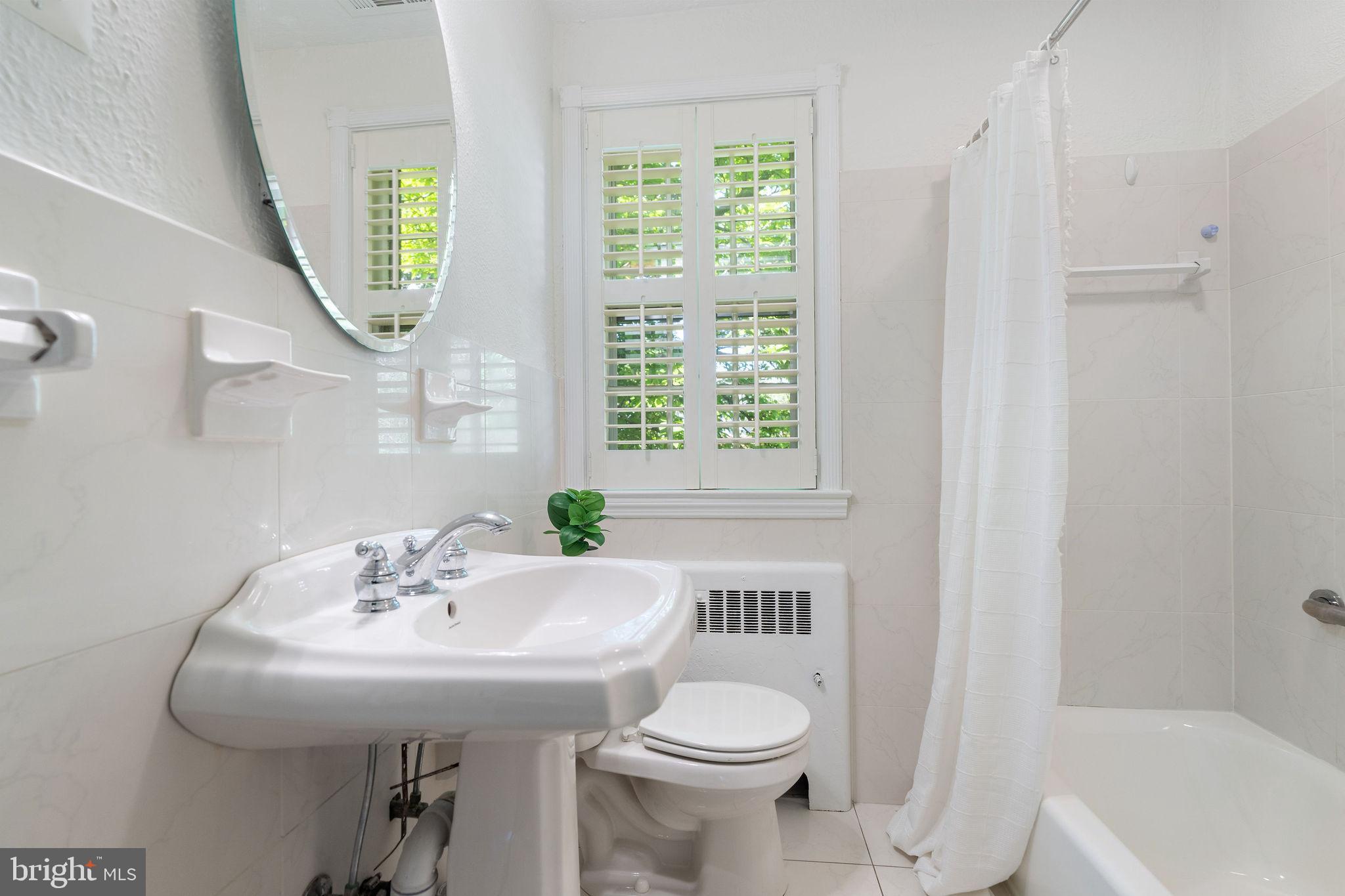 19 Dunkirk Road Baltimore, MD 21212 - Photo 18 of 37 a bathroom with a sink a toilet and a mirror
