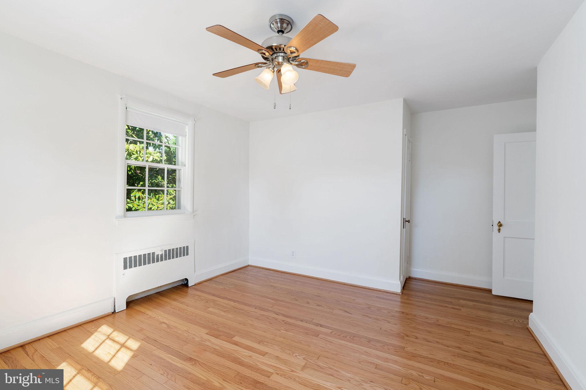 19 Dunkirk Road Baltimore, MD 21212 - Photo 21 of 37 an empty room with wooden floor chandelier fan and windows