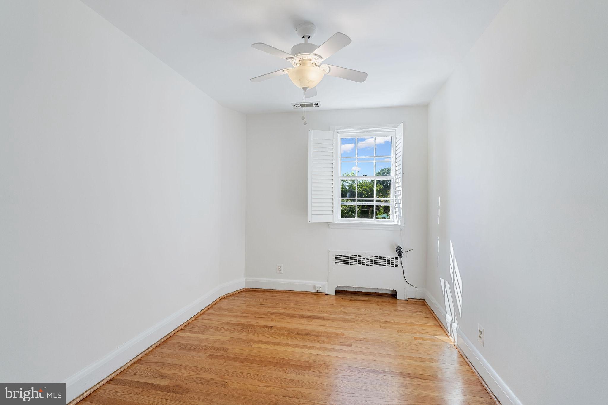 19 Dunkirk Road Baltimore, MD 21212 - Photo 22 of 37 wooden floor in an empty room with a window