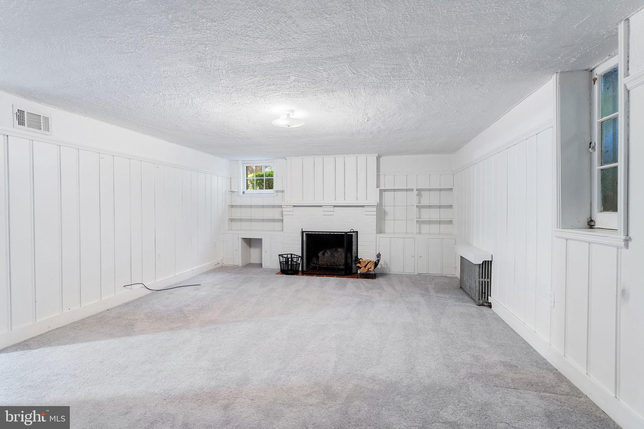 19 Dunkirk Road Baltimore, MD 21212 - Photo 24 of 37 an empty room with furniture and a fireplace