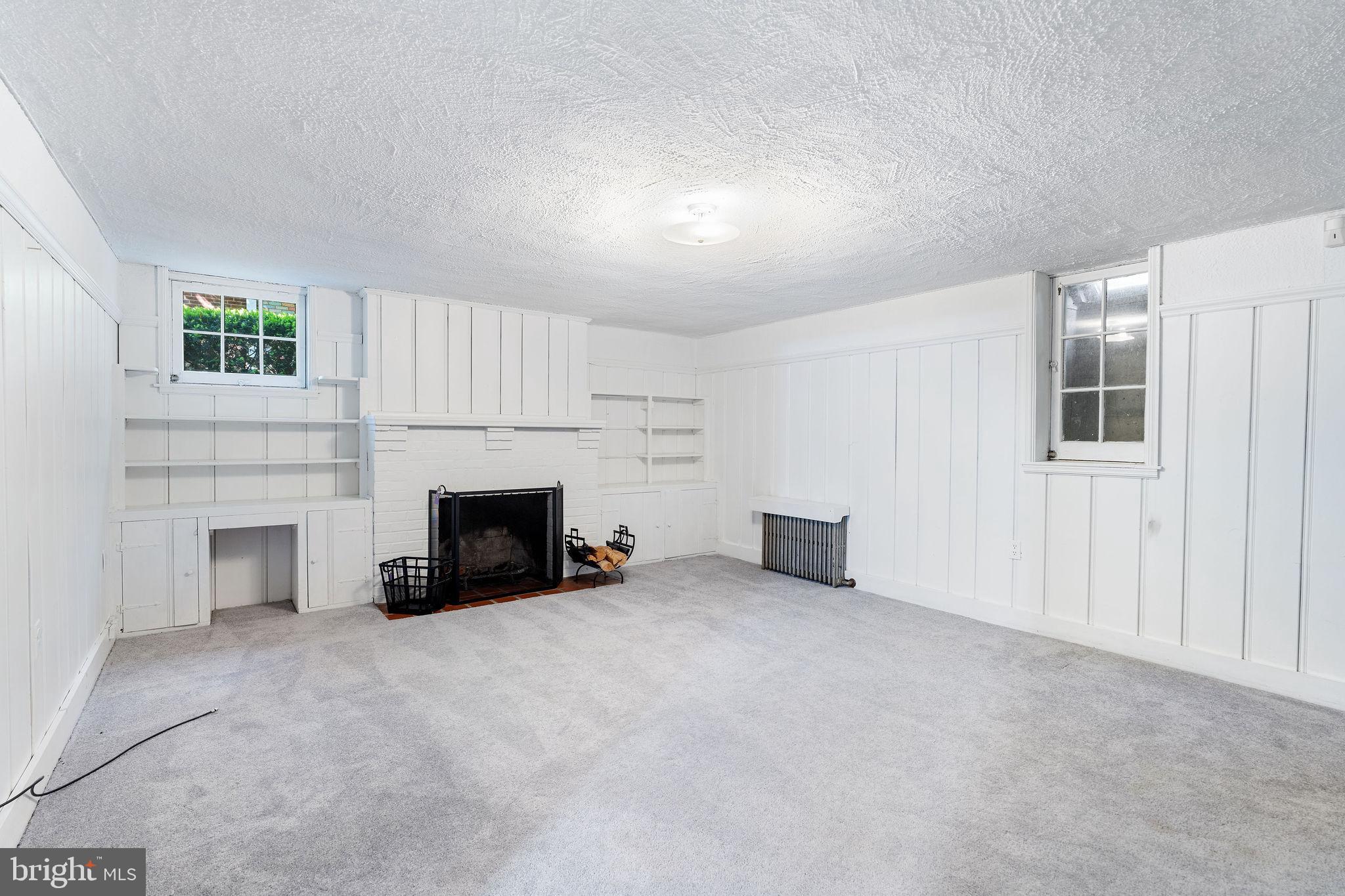 19 Dunkirk Road Baltimore, MD 21212 - Photo 26 of 37 an empty room with furniture and a fireplace
