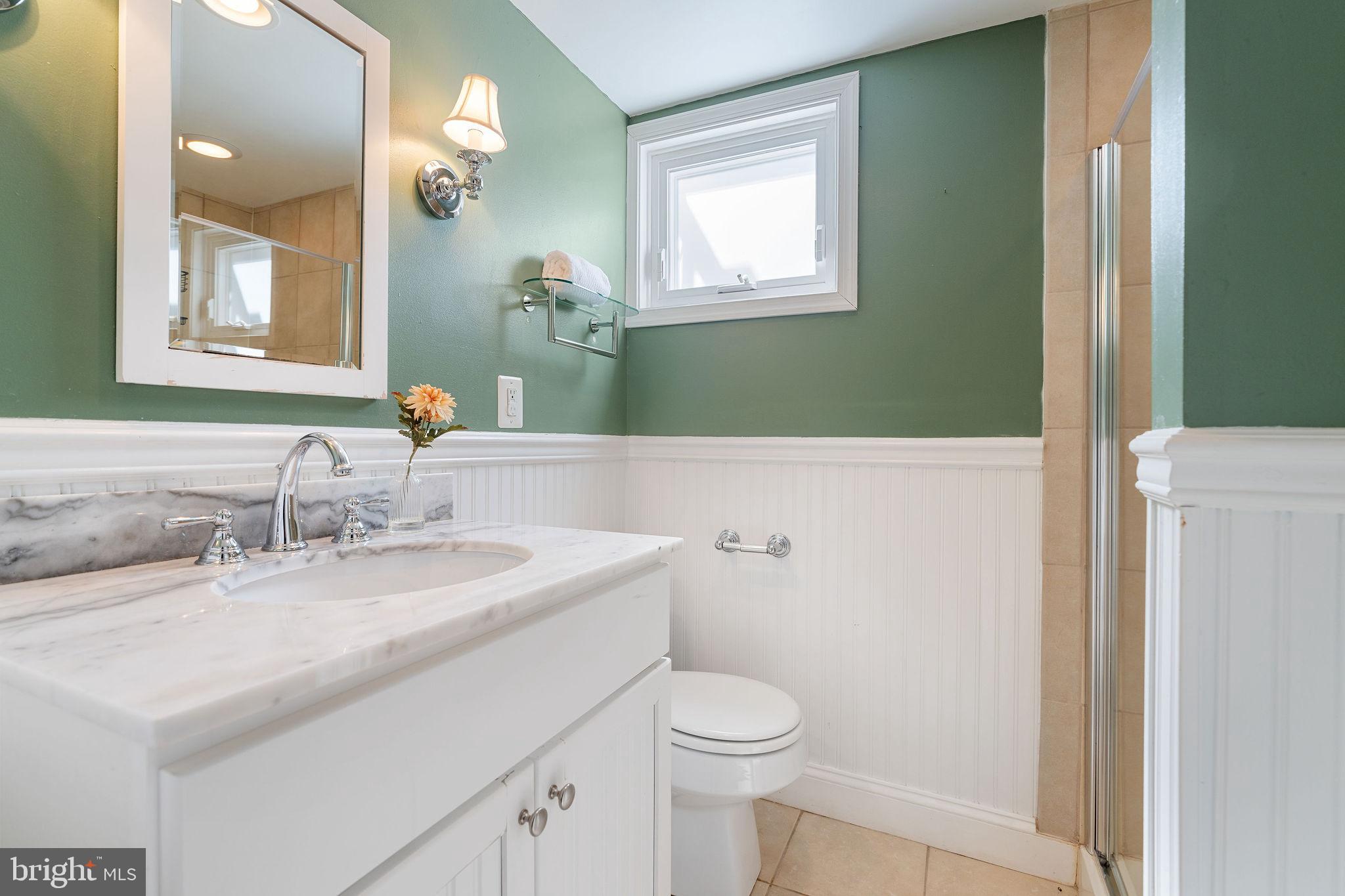 19 Dunkirk Road Baltimore, MD 21212 - Photo 27 of 37 a bathroom with a sink a toilet and a mirror