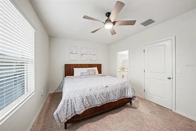 a bedroom with a bed and window