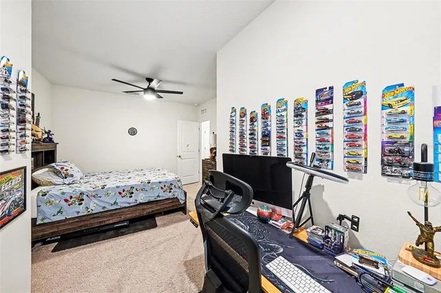 a bedroom with furniture and a large window