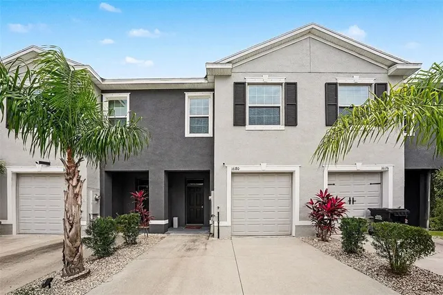 a front view of a house with plants
