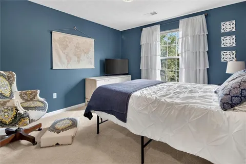 a bed room with a bed and a tv