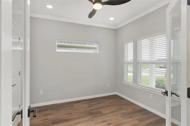 a view of an empty room with wooden floor