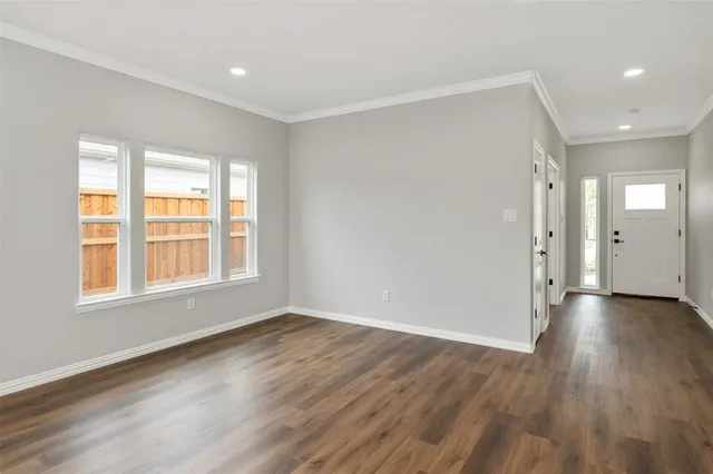 a kitchen with granite countertop cabinets stainless steel appliances and wooden floor